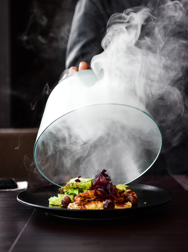 Steaming dish with smoke effect on a dark background